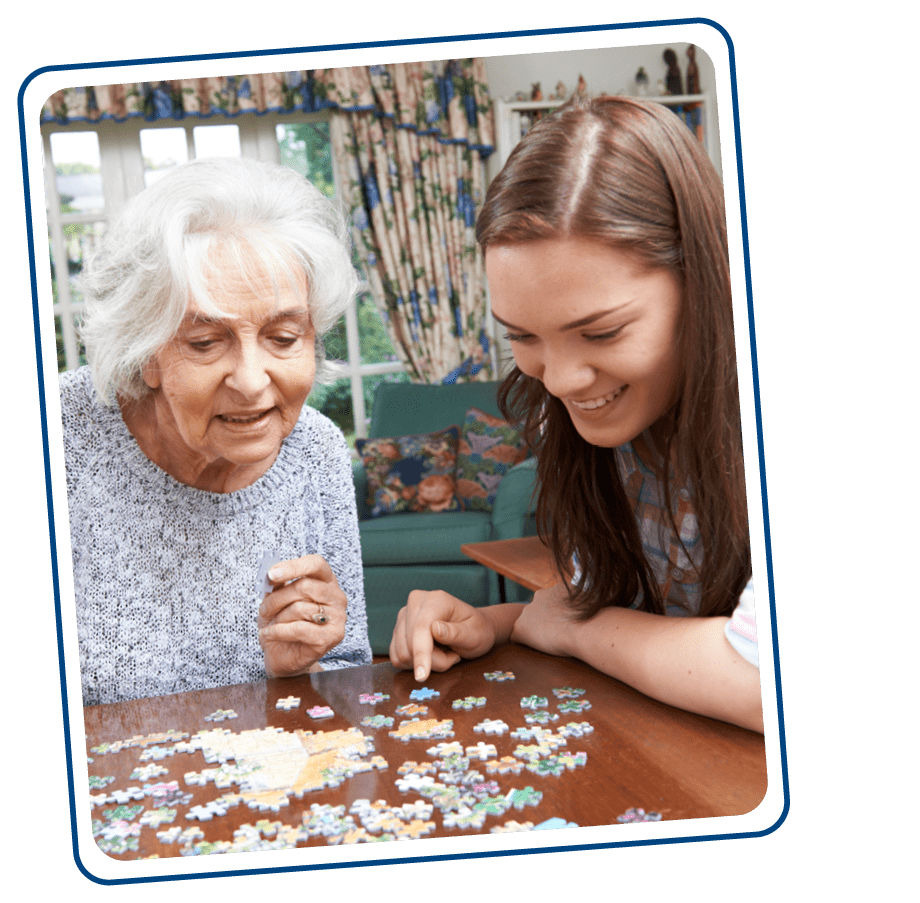 Elderly woman on Medicaid doing puzzle with daughter (caregiver) in NY home